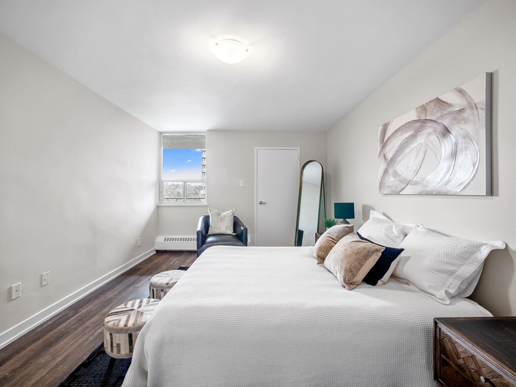 a bedroom with a large bed and a mirror