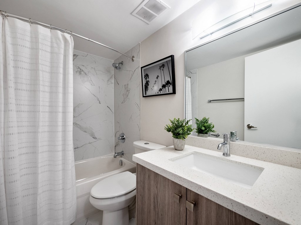 a bathroom with a sink toilet and bathtub in a 555 waverly unit