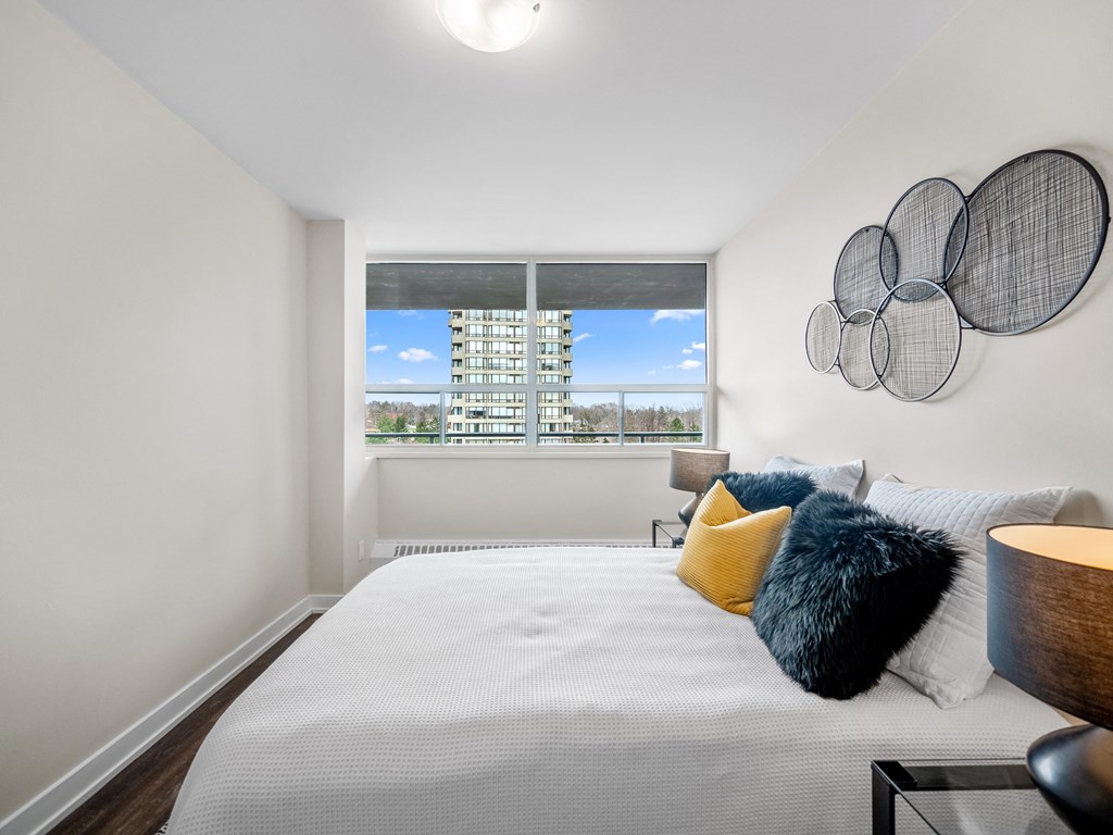a bedroom with a large bed and a large window