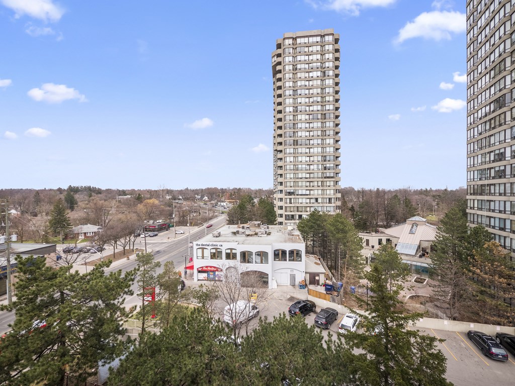 an aerial view of a tall building with a blue sky in the background
