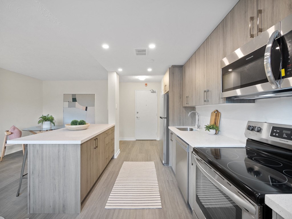 a kitchen with white countertops and wooden cabinets