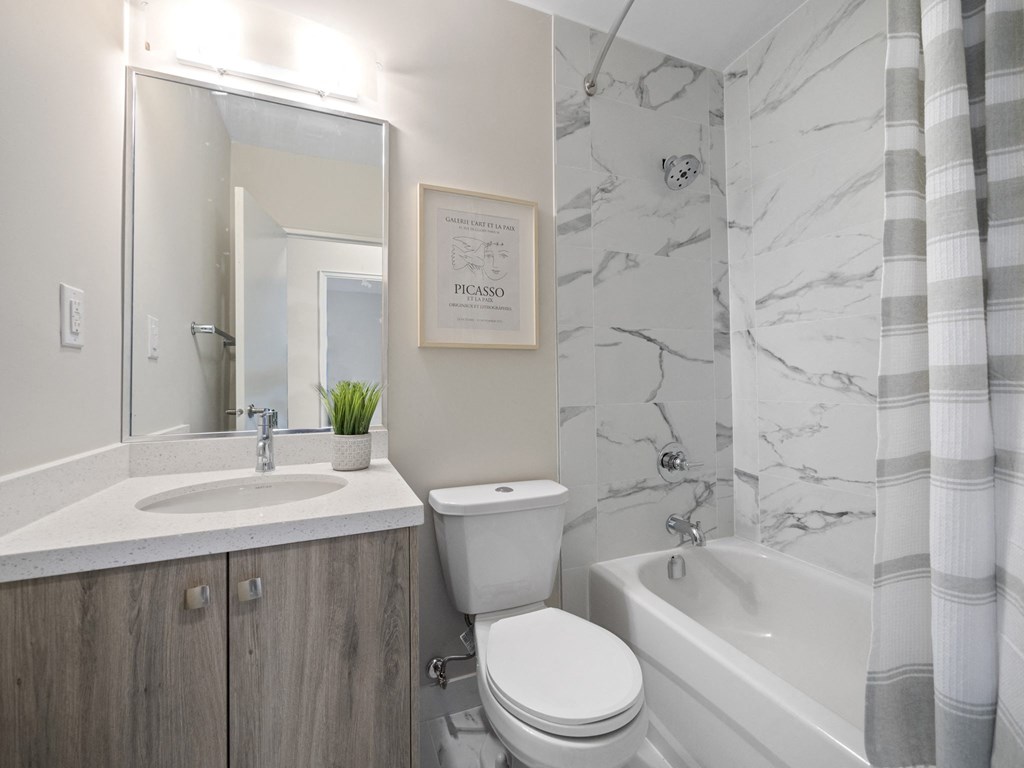 a bathroom with a sink toilet and bathtub in a 555 waverly unit