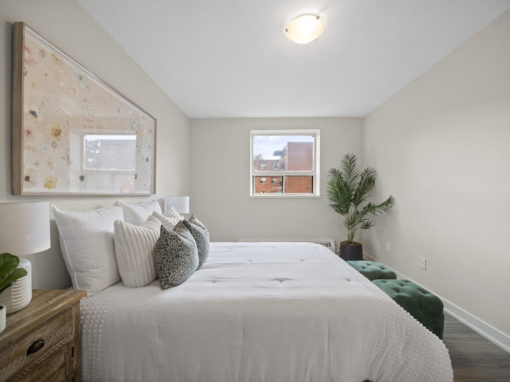 a bedroom with a large bed and a window