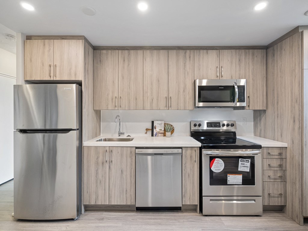a kitchen with wooden cabinets and stainless steel appliances
