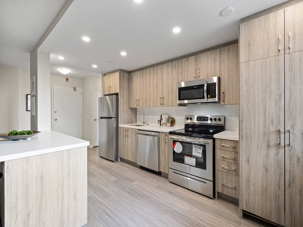 a kitchen with wooden cabinets and stainless steel appliances