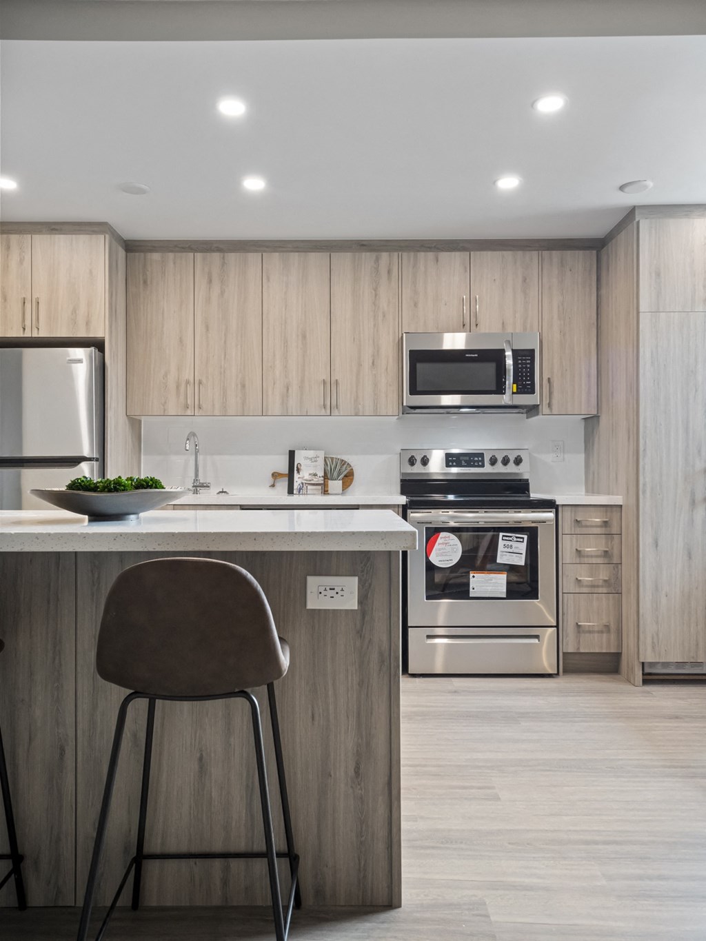 a kitchen with wooden cabinets and a white counter top