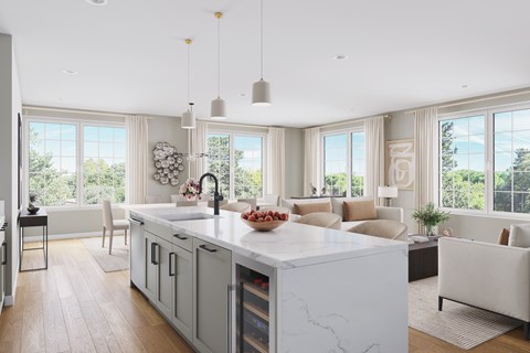 a large white kitchen with a large island in the middle of it