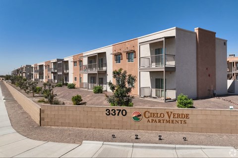 A row of apartment buildings with the number 3370 and the name Cielo Verde Apartments on a wall.