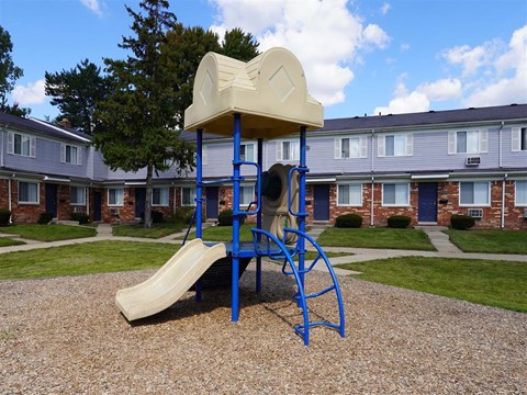 a playground with a swing set and a slide