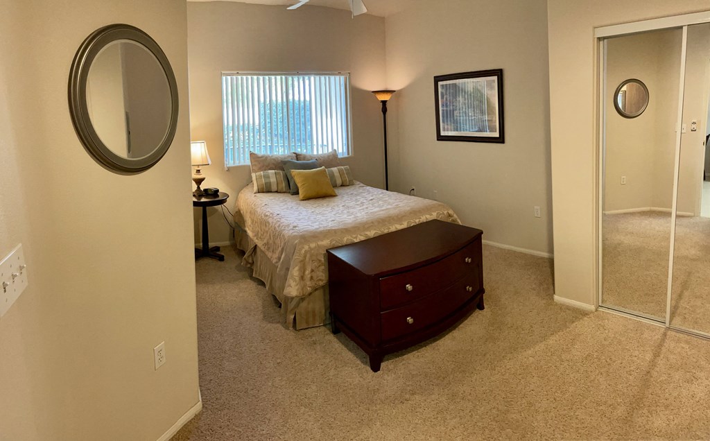 a bedroom with a bed and a dresser