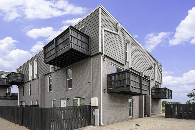 A modern house with balconies on the second floor.