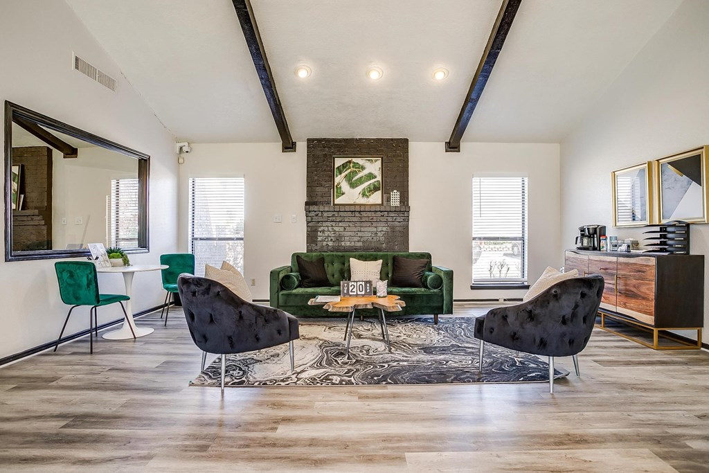 a living room with a green couch and chairs