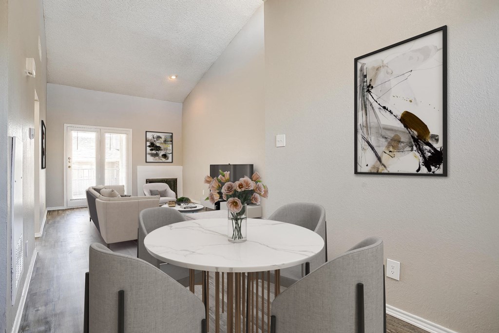a dining room with a white table and chairs and a living room