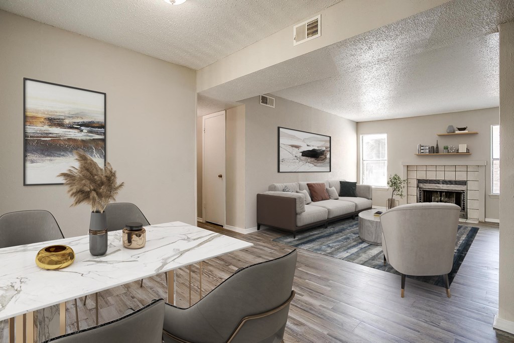 an open living room and dining room with a table and chairs