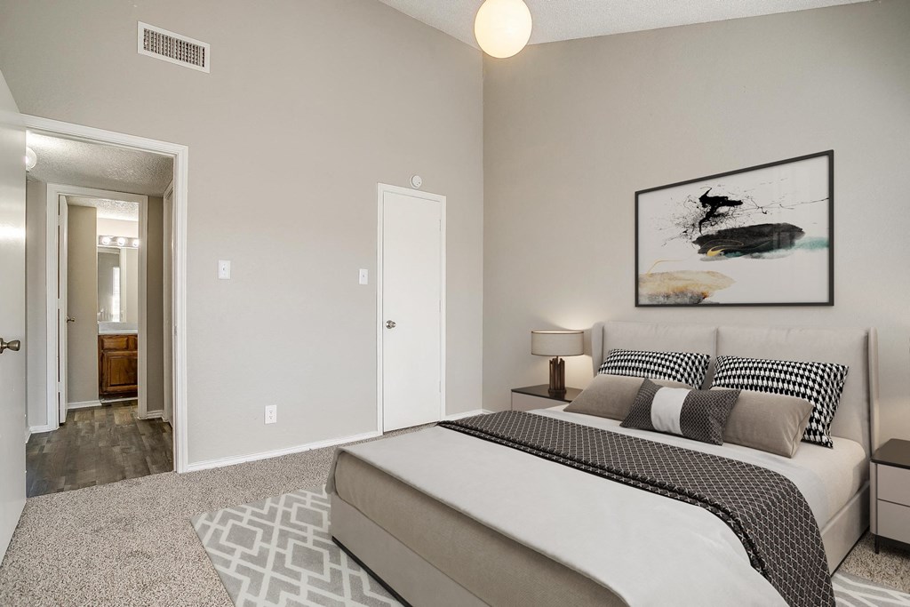 a bedroom with a bed and a door to a bathroom