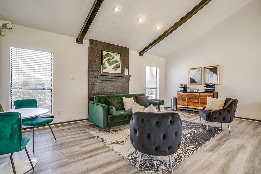 a living room with a couch and chairs and a table