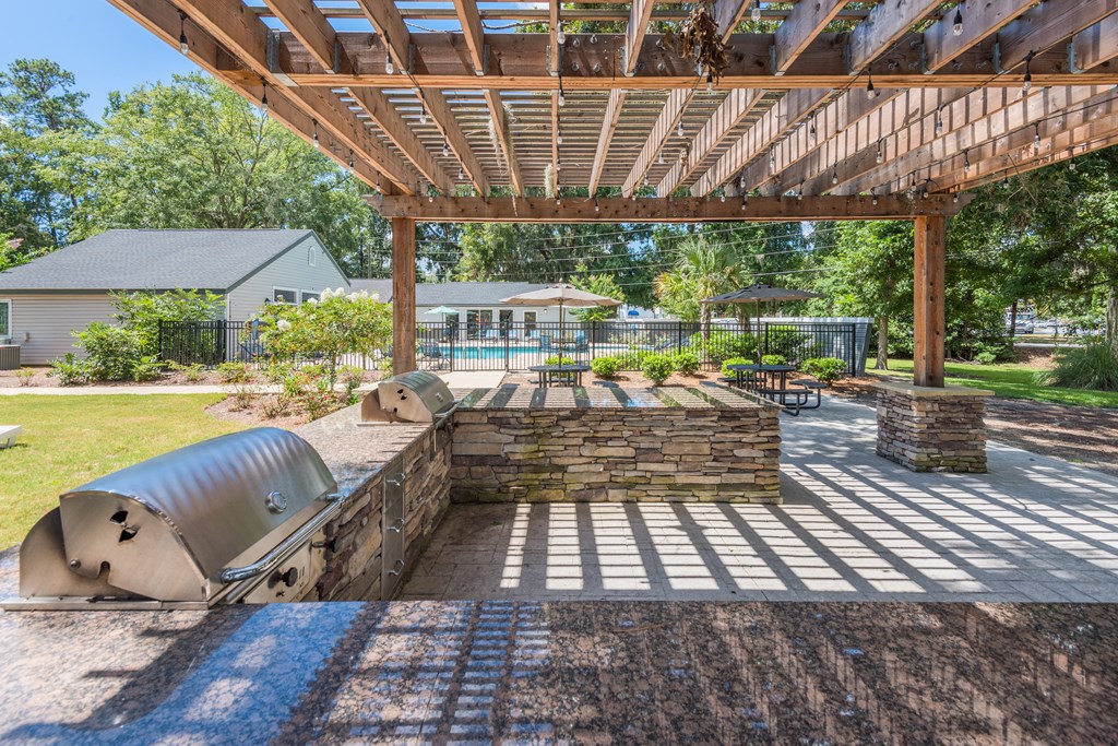 take advantage of the shady surroundings under the pergola at the whispering winds apartments in pear