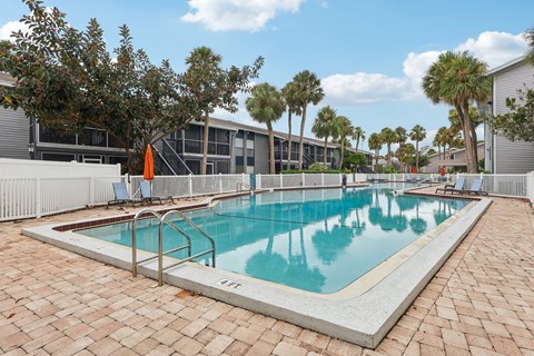 A rectangular pool with a white border and a metal ladder on the side.