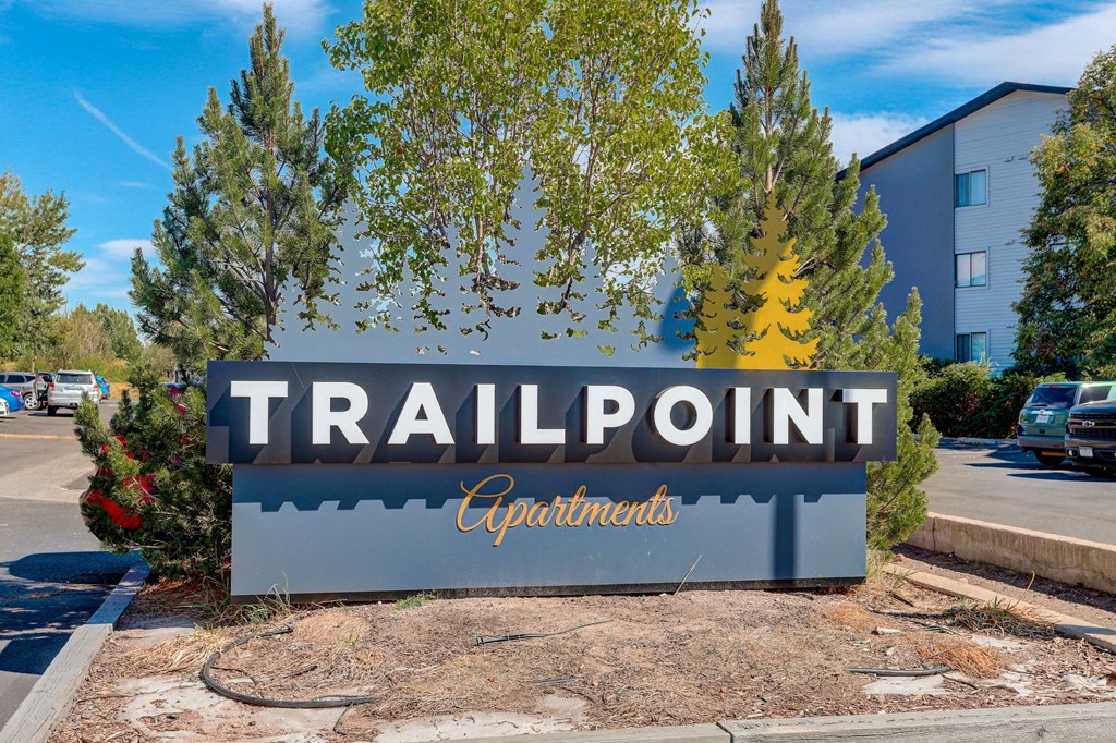 the sign for trailpoint headquarters in front of a parking lot
