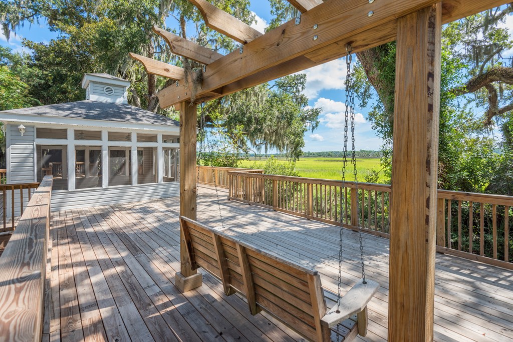 a large deck with a swing and a gazebo