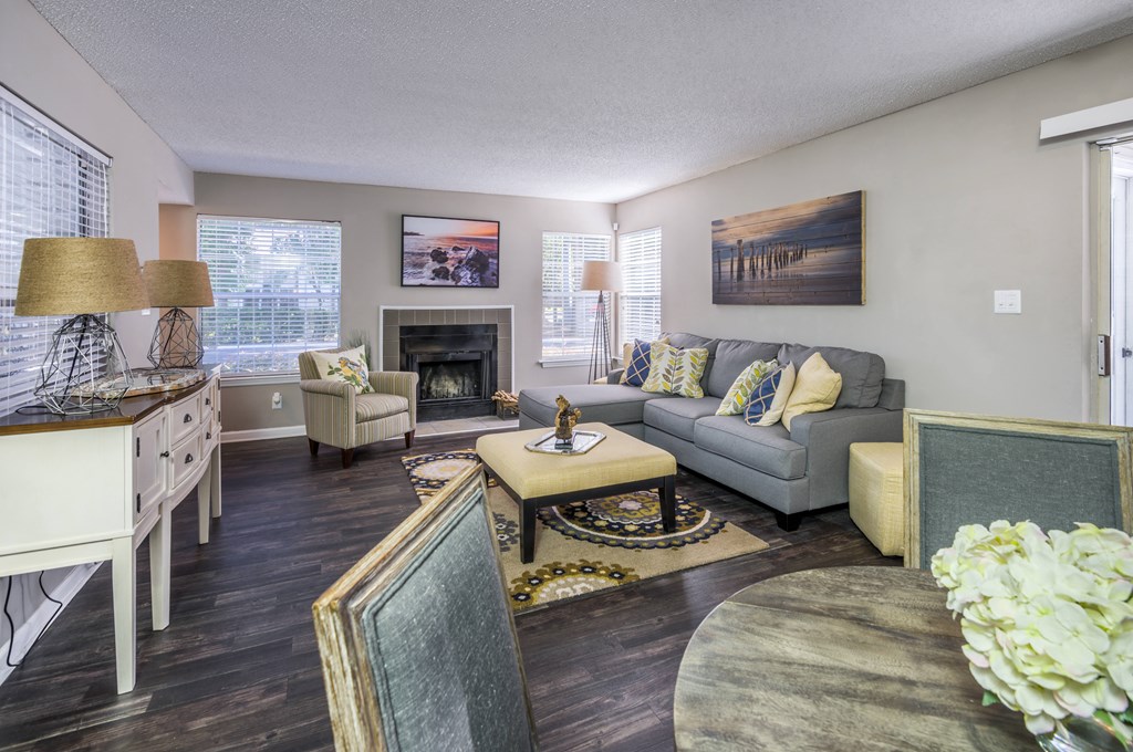 a living room with a couch table and chairs and a fireplace