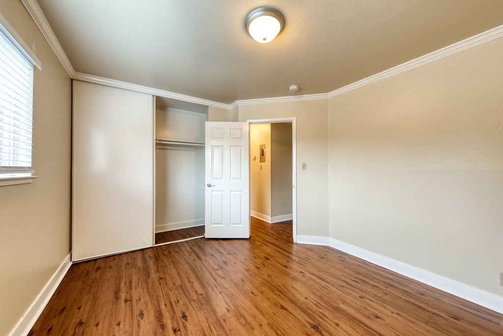 a living room with hardwood floors and white walls