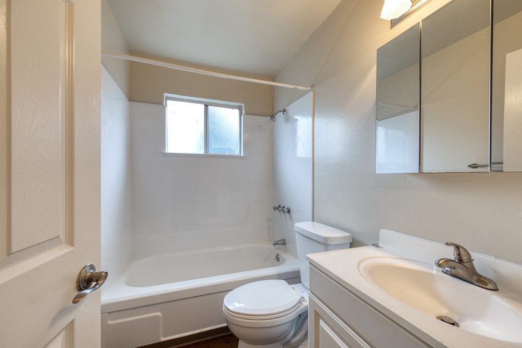 a bathroom with a toilet sink and bathtub
