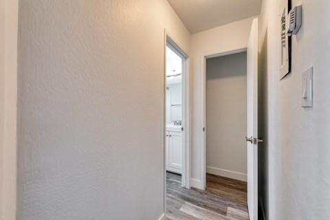 a bedroom with a medium sized window and a door that leads to a bathroom