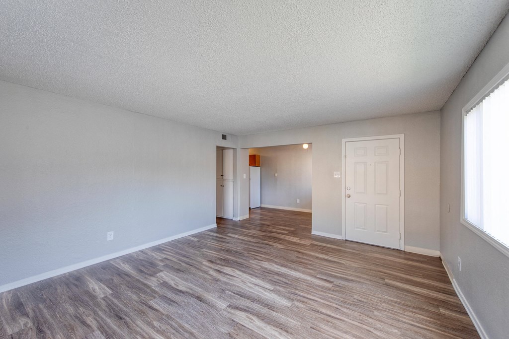 a spacious living room with hardwood flooring