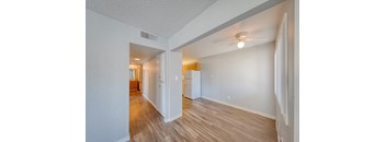 A room with a white wall and a wooden floor.