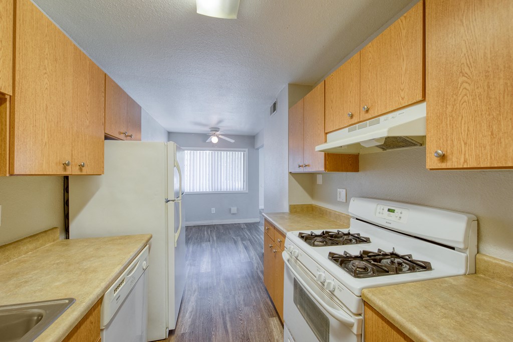 a kitchen with white appliances and wooden cabinets