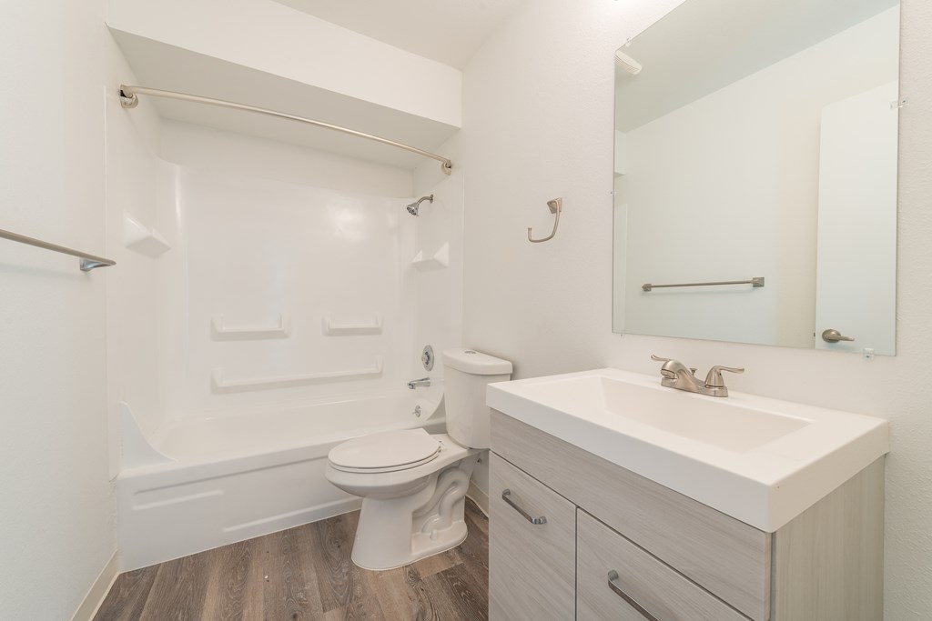 a bathroom with a sink toilet and bathtub in a 555 waverly unit