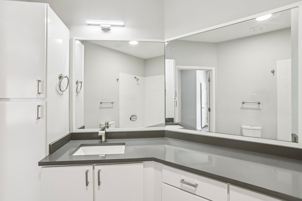 A bathroom with a sink and mirror.