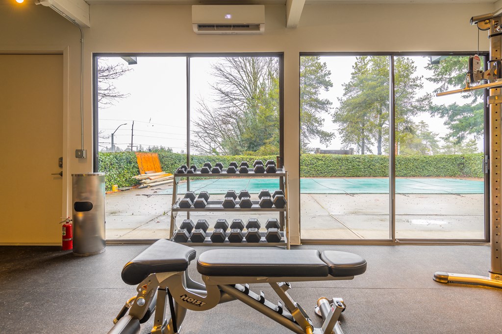 a gym with a pool in the background
