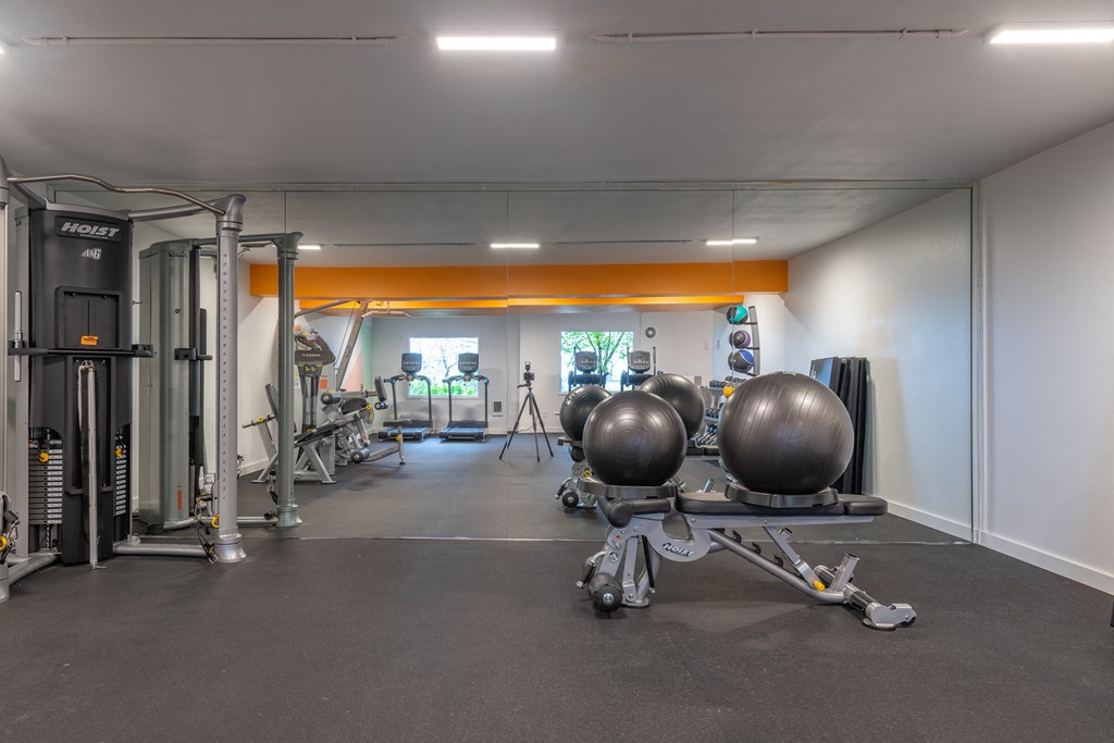 a gym with weights machines and other exercise equipment