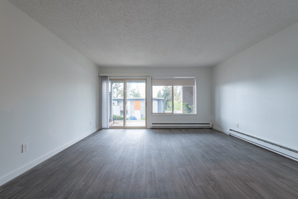 an empty living room with a sliding glass door