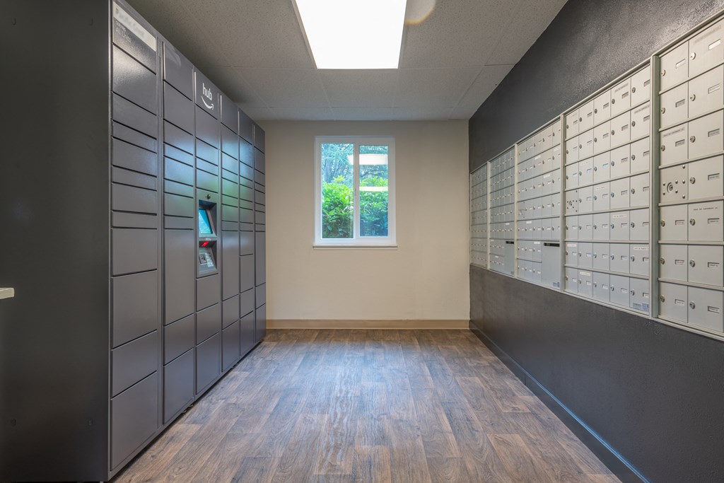 a photo of the inside of a mailroom with lockers and a window
