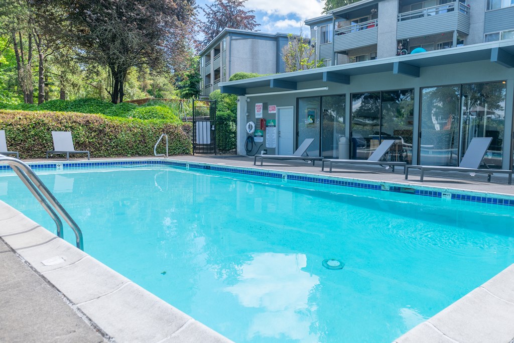 a swimming pool with a building in the background