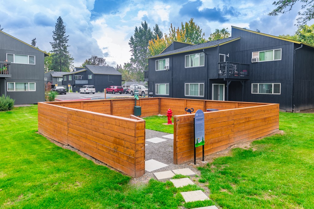 a wooden privacy fence with a fire hydrant in the background