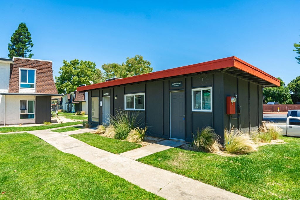 a black building with a red roof