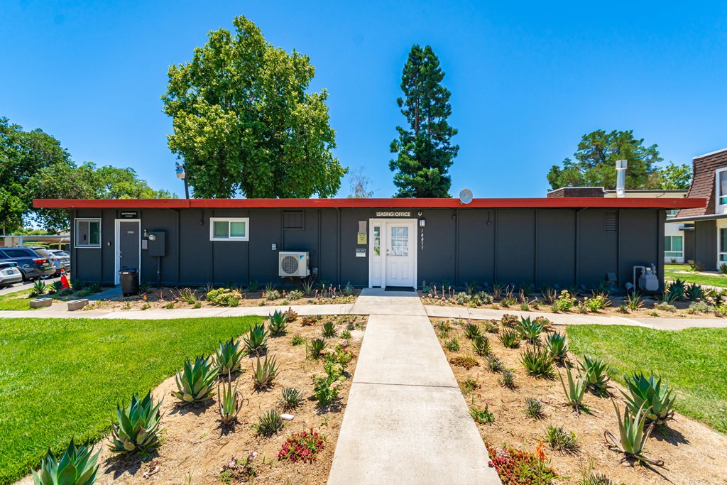 a building with a red roof and a white door