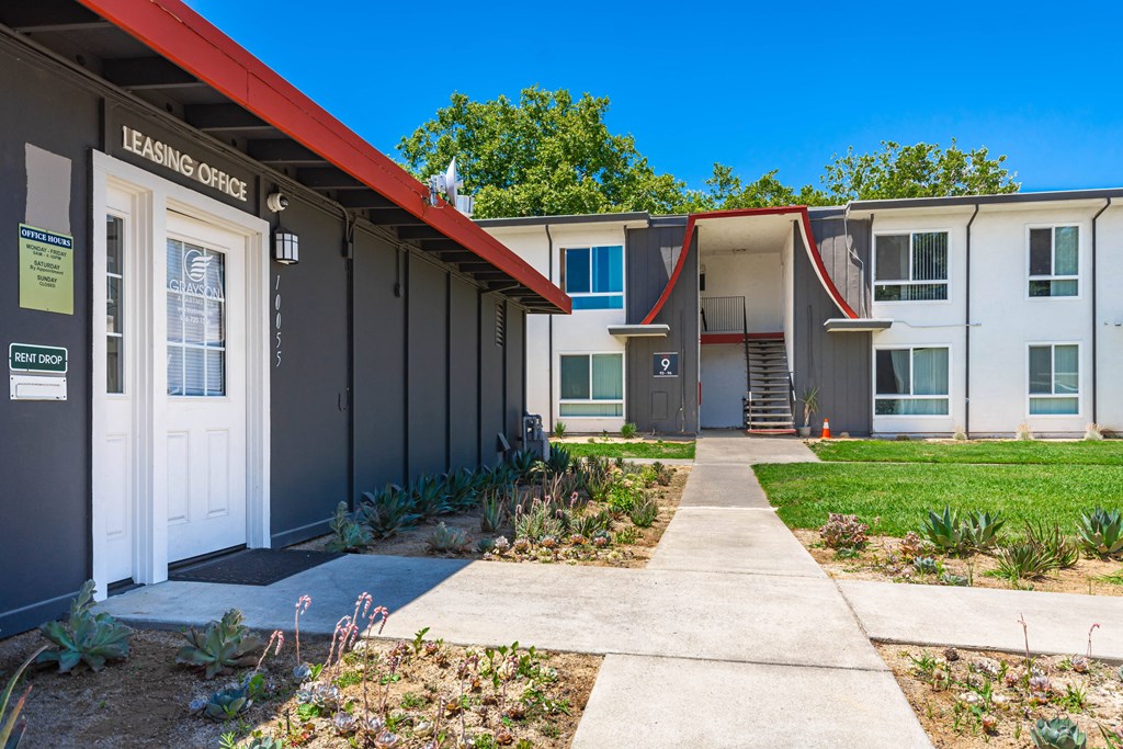 a sidewalk leading to the entrance of a building