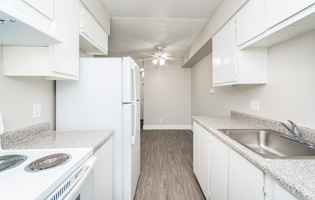 a kitchen with white cabinets and white appliances
