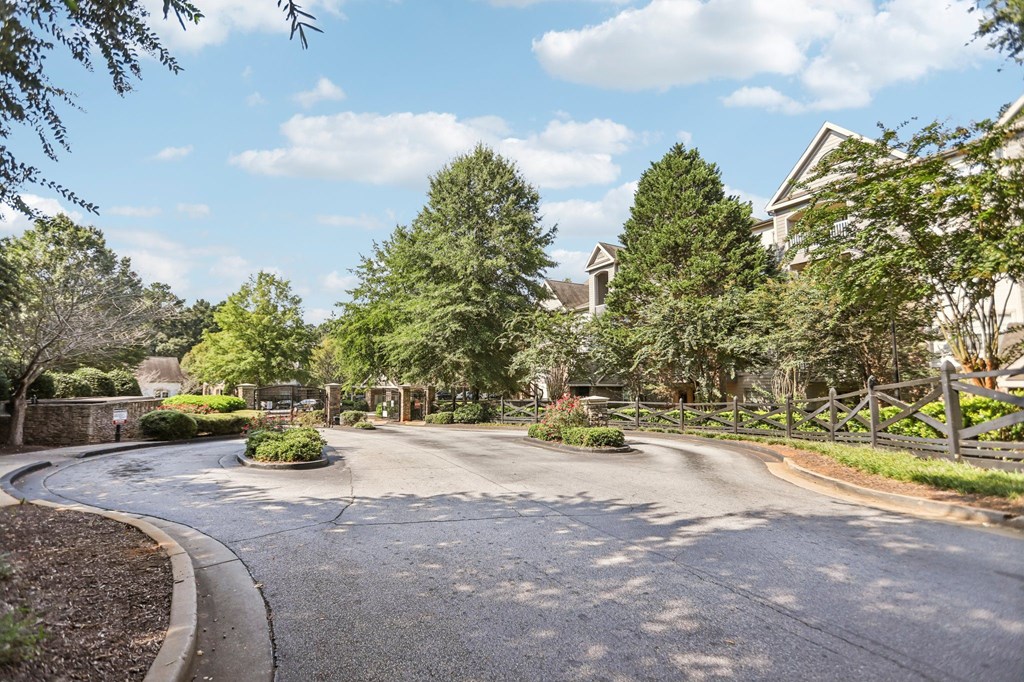 A residential street with houses on both sides and a sidewalk.