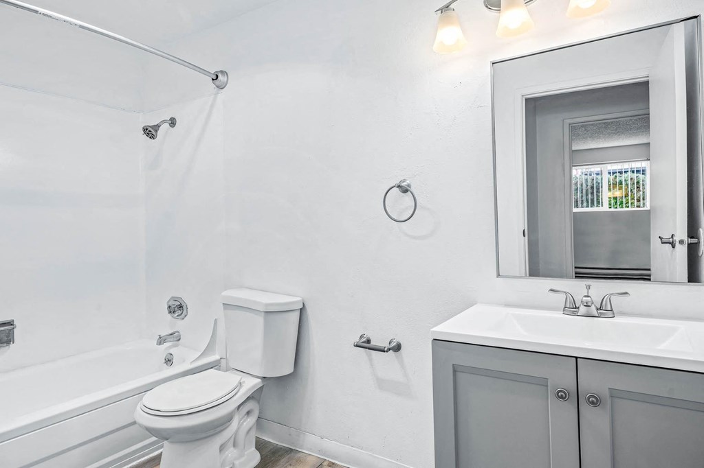 a bathroom with a sink toilet and bathtub