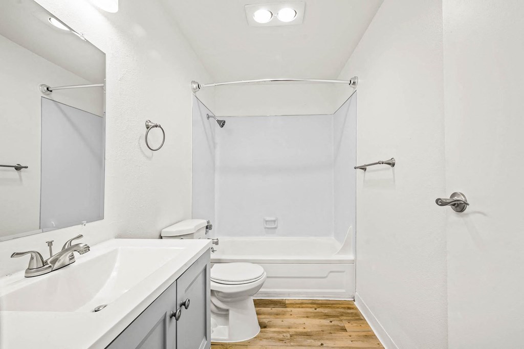 a bathroom with a toilet sink and bathtub