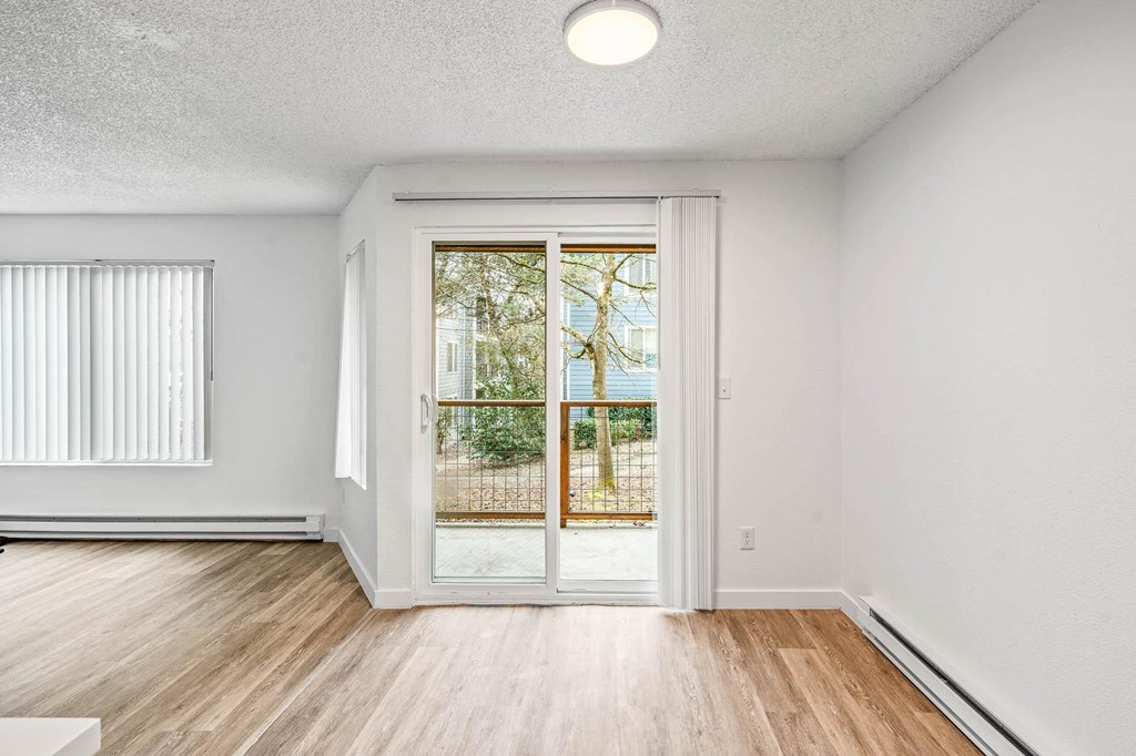 a living room with hardwood floors and white walls