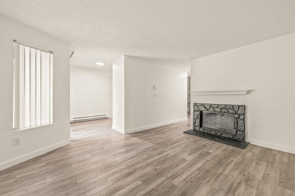 a living room with a fireplace and hardwood floors