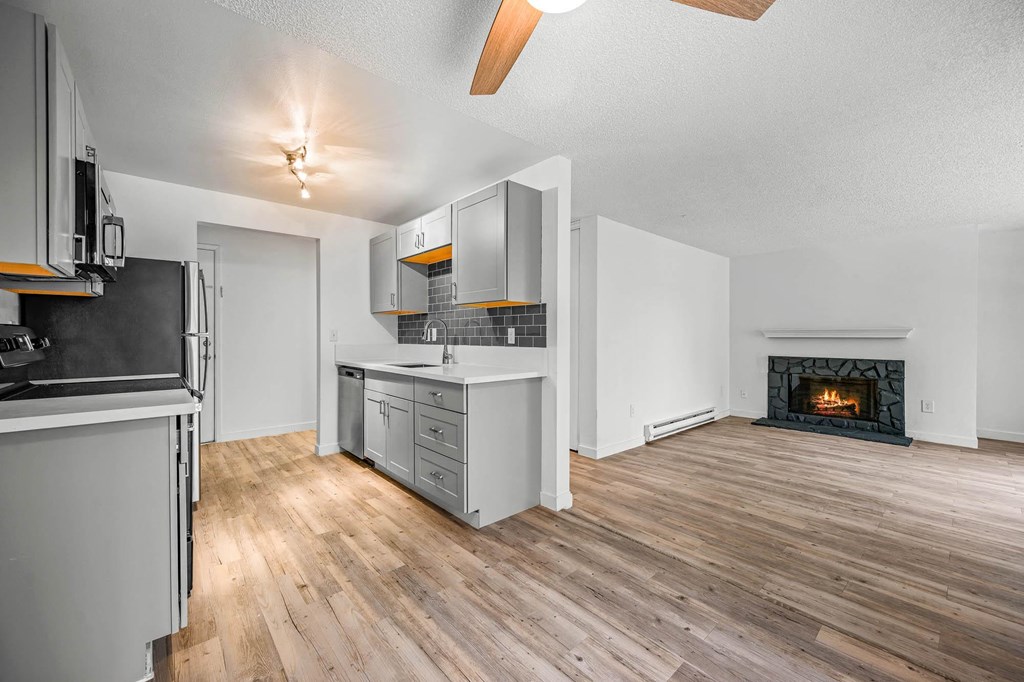 a kitchen and living room with a fireplace