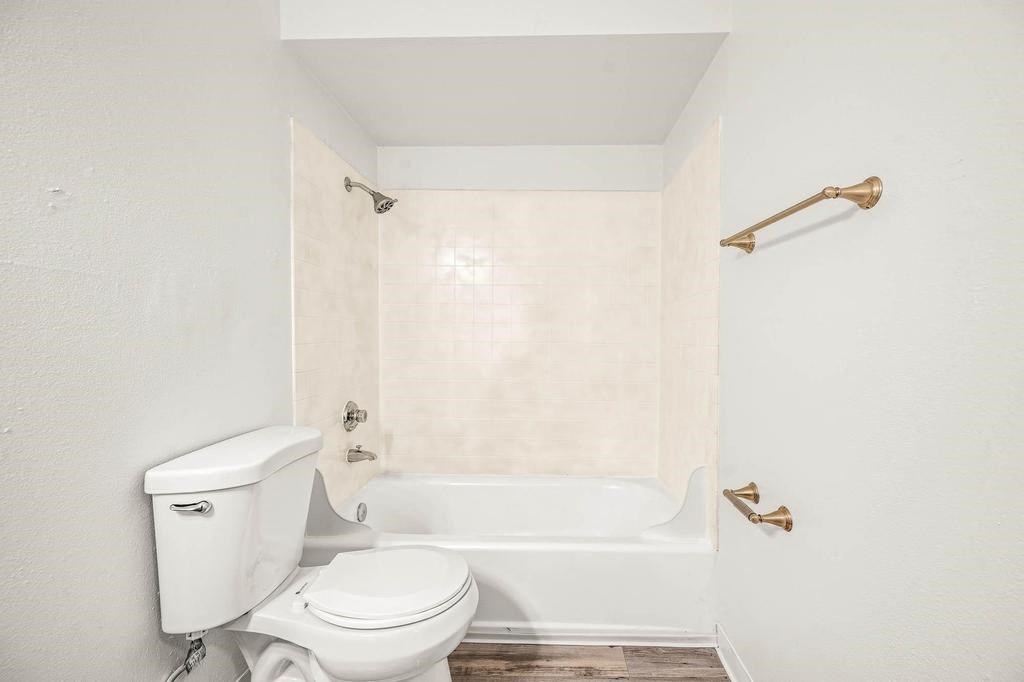 a bathroom with a toilet and a bath tub